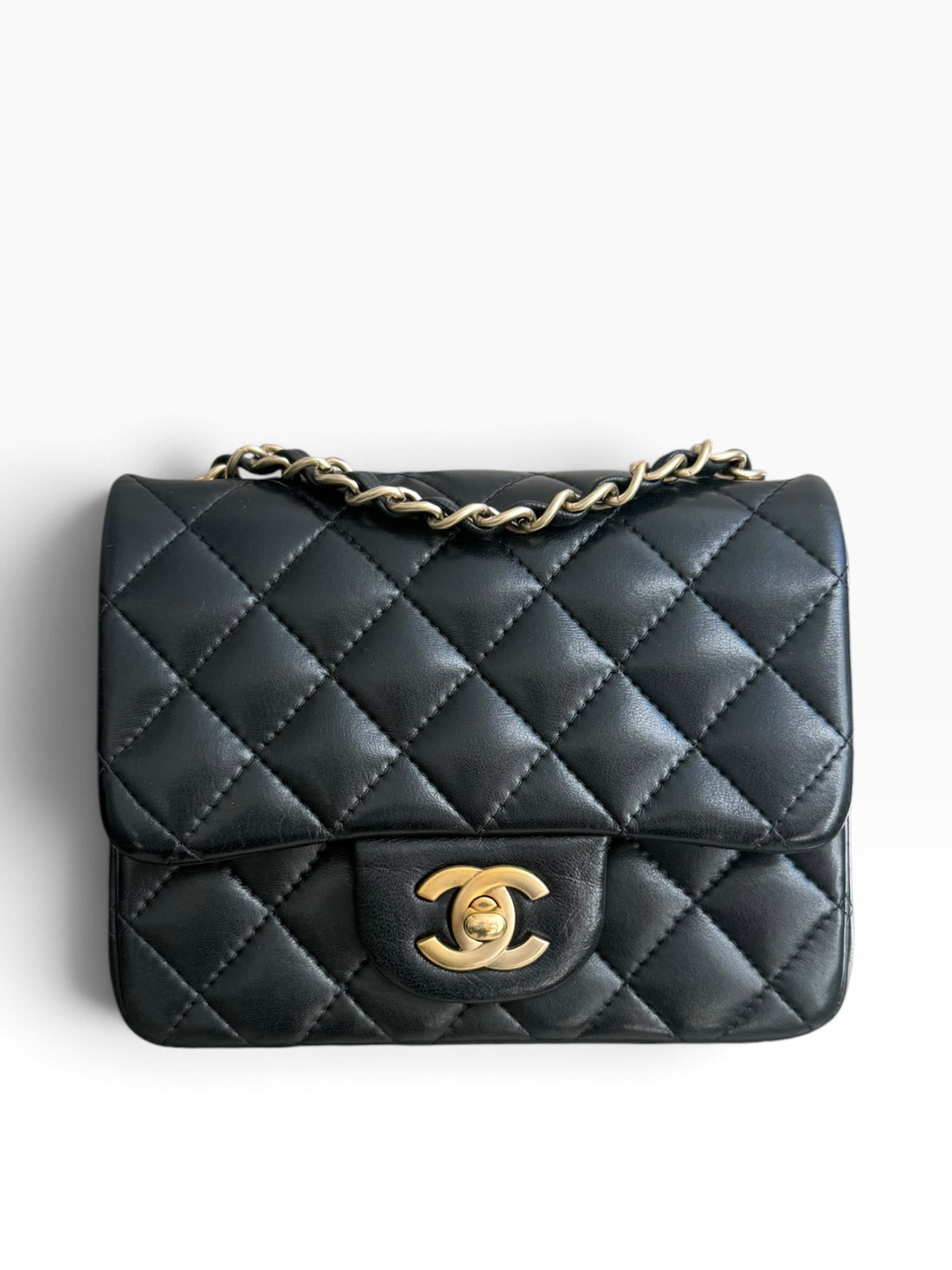 Chanel Classic Flap Bag Mini Square aus schwarzem Lammleder mit goldfarbenem Metall.